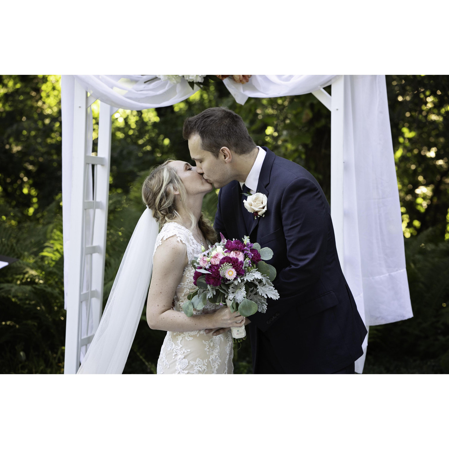 Getting married in Grandpa's Backyard. We actually had to retake this photo and kiss twice because my veil fell off the first time!