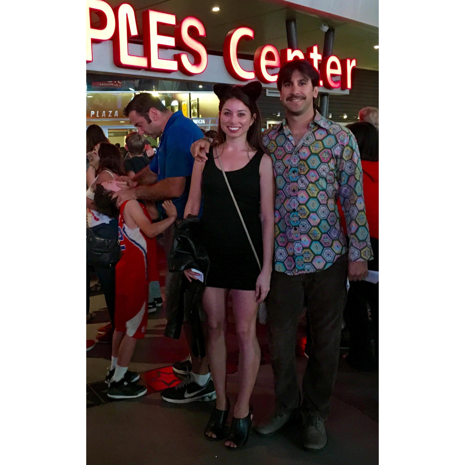 Halloween with a guy dressed up as a dad choking his son in the background
