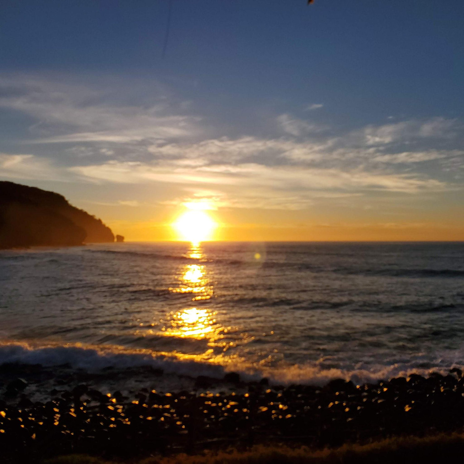 Our first trip — a sunrise over the ocean in El Salvador that felt like a new beginning.