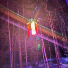 Picture of a lantern at the ice castle walk through the woods.