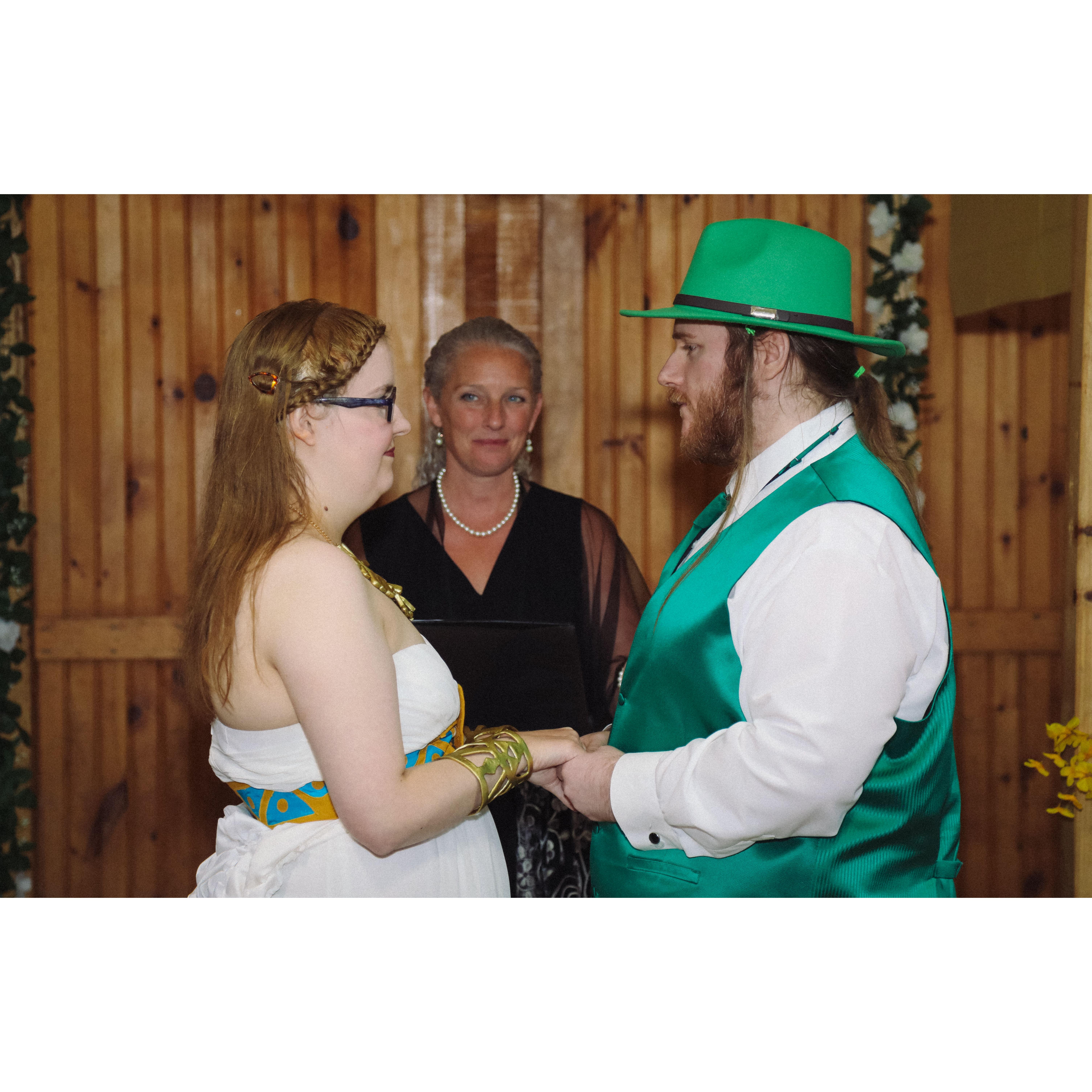during the ceremony, Sara and Herb holding hands under the arch with the officiant,