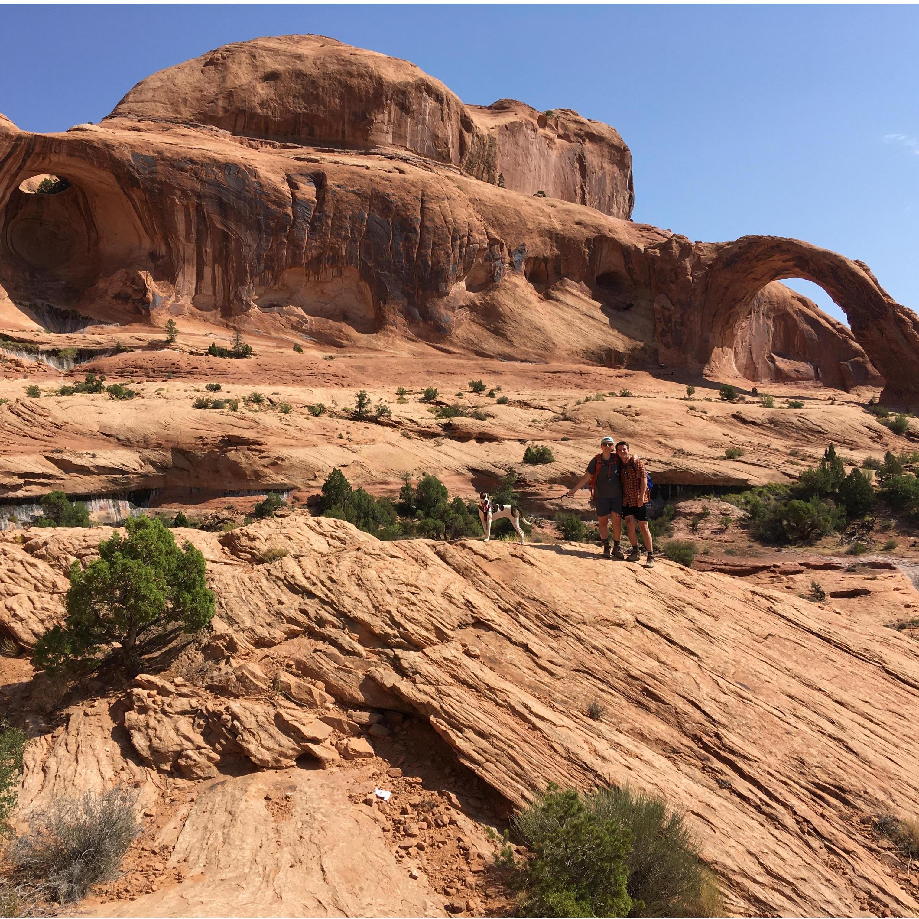 Sofia, Liam, and Beans in front of Corona Arch, Utah