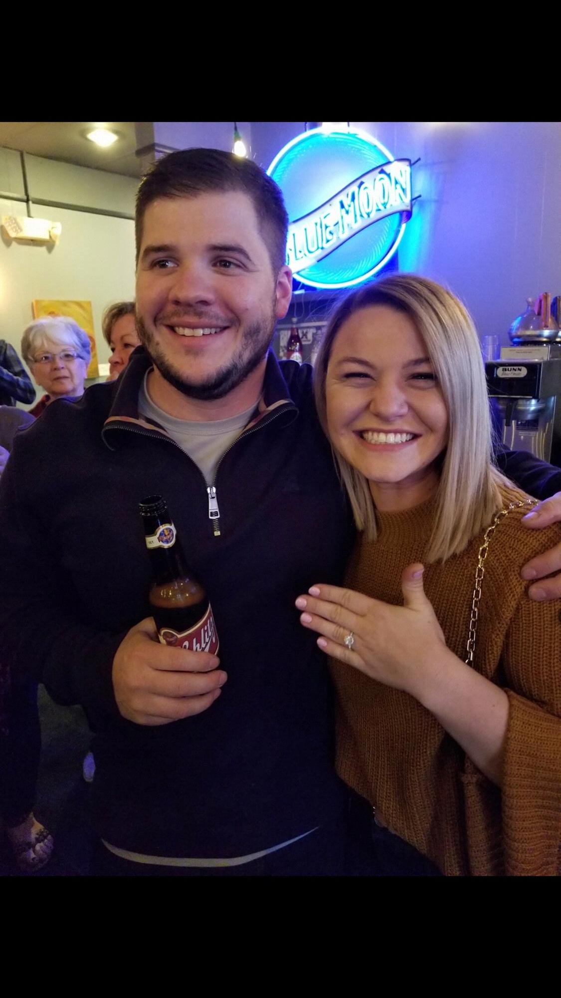 Ring on her finger, beer in his hand!
