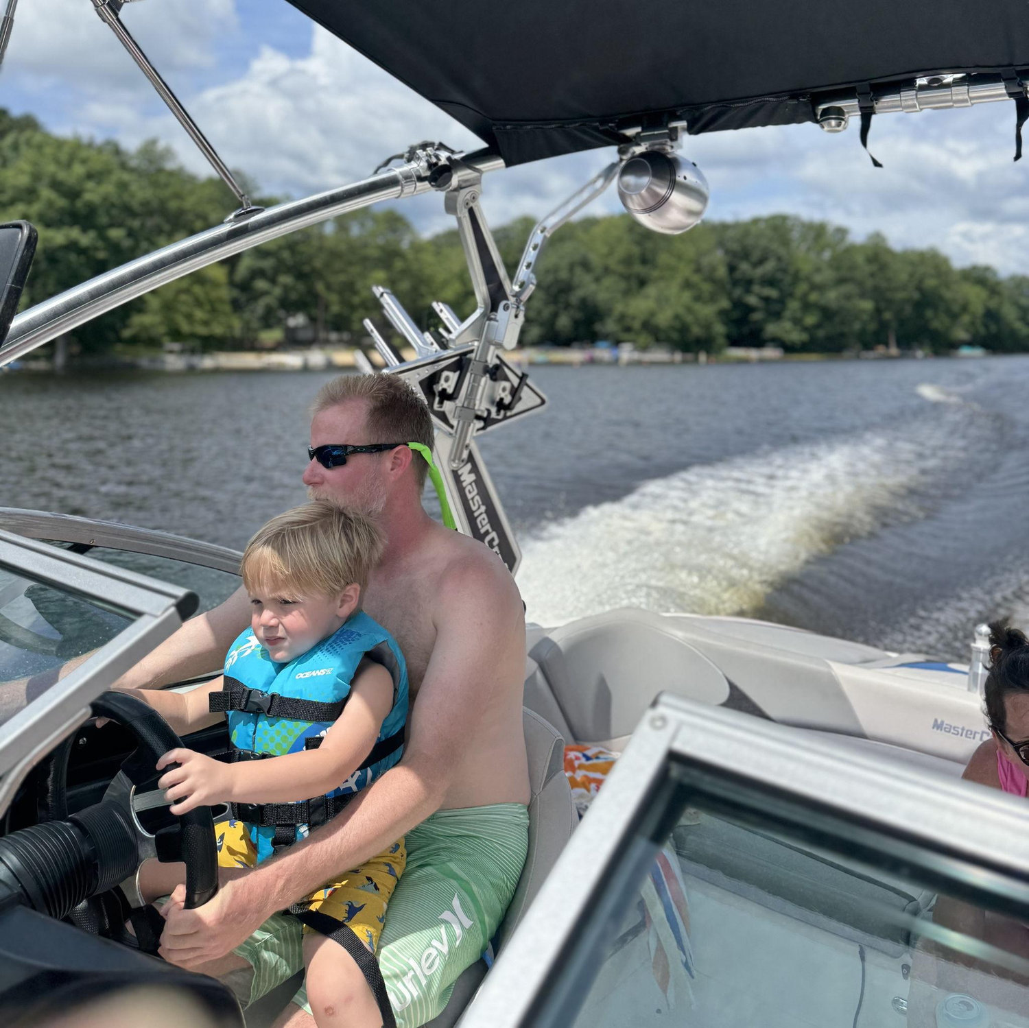 Grandpa teaching Jack how to drive the boat