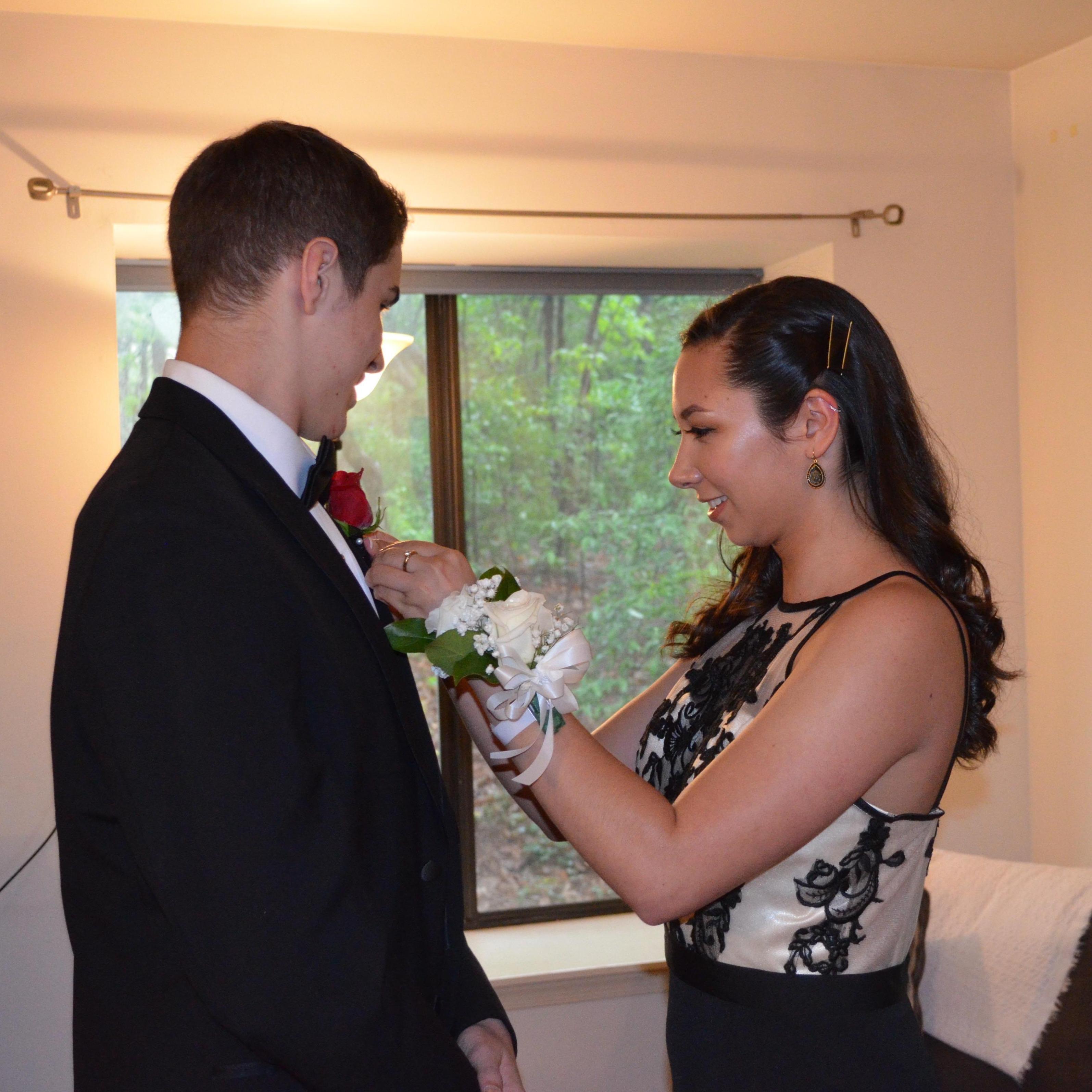 Pinning Jack's boutonniere on before Junior prom.