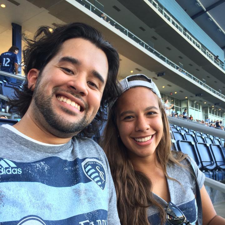 Siblings watching soccer.