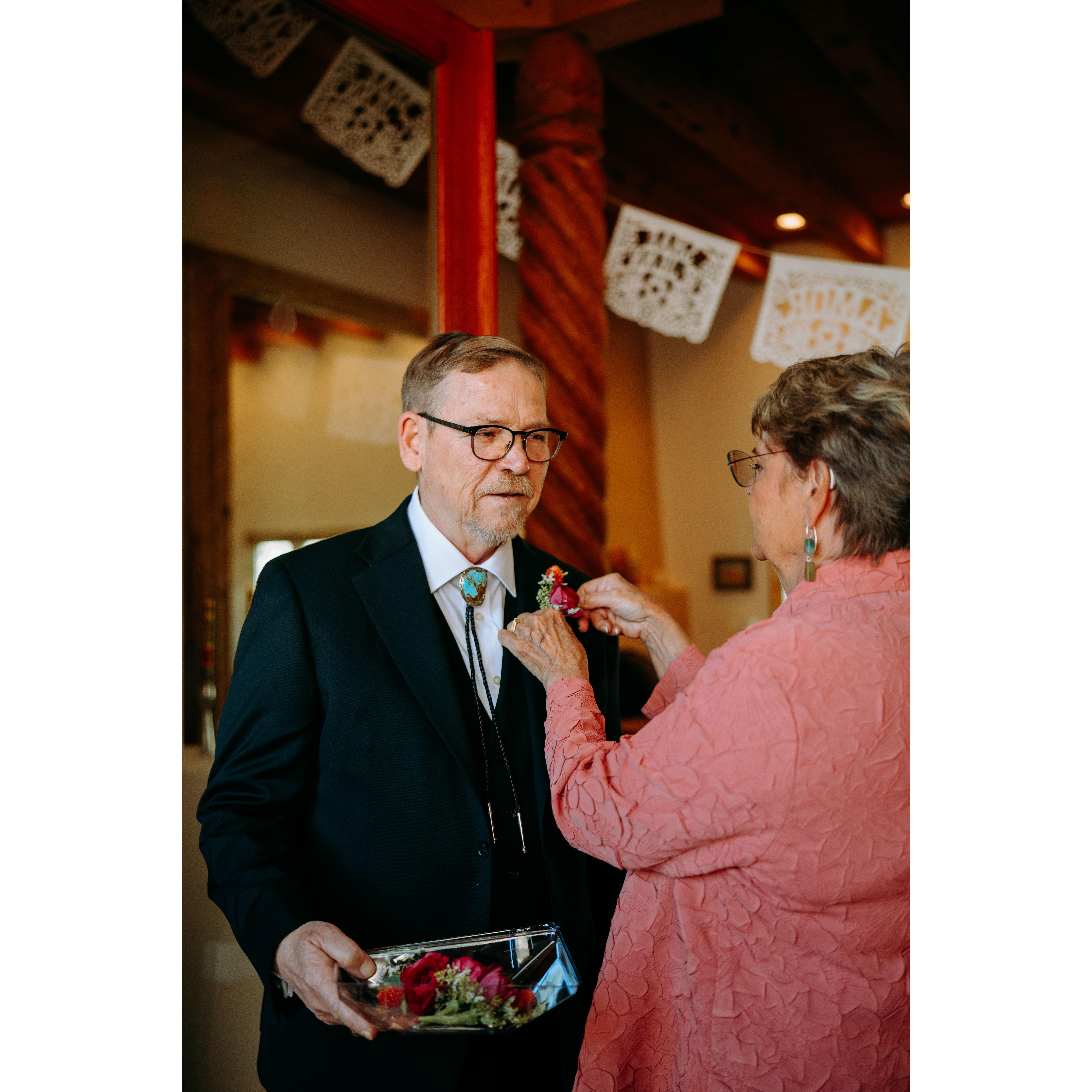 Jonathan (Jennifer's Dad) and Carol (Shae's Mom) pinning a boutonniere