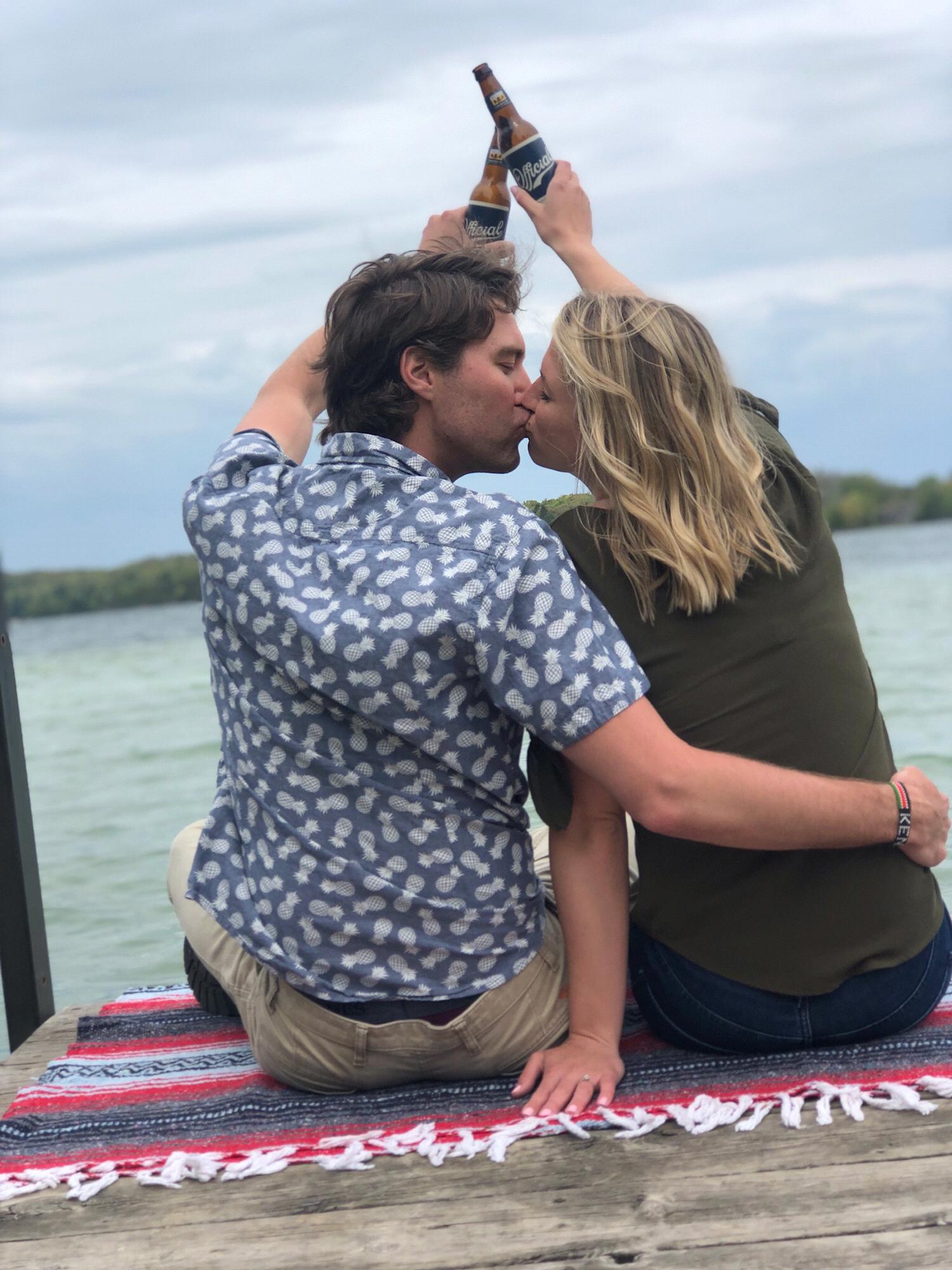 Engaged in Traverse City, MI toasting at Cedar Lake! Photo credit: Devon Burke