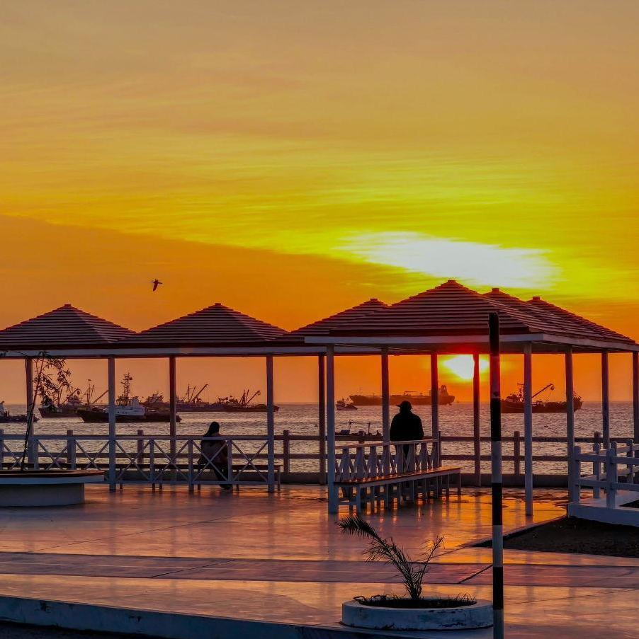 Find a sit to watch the sunset at the Costanera Walk