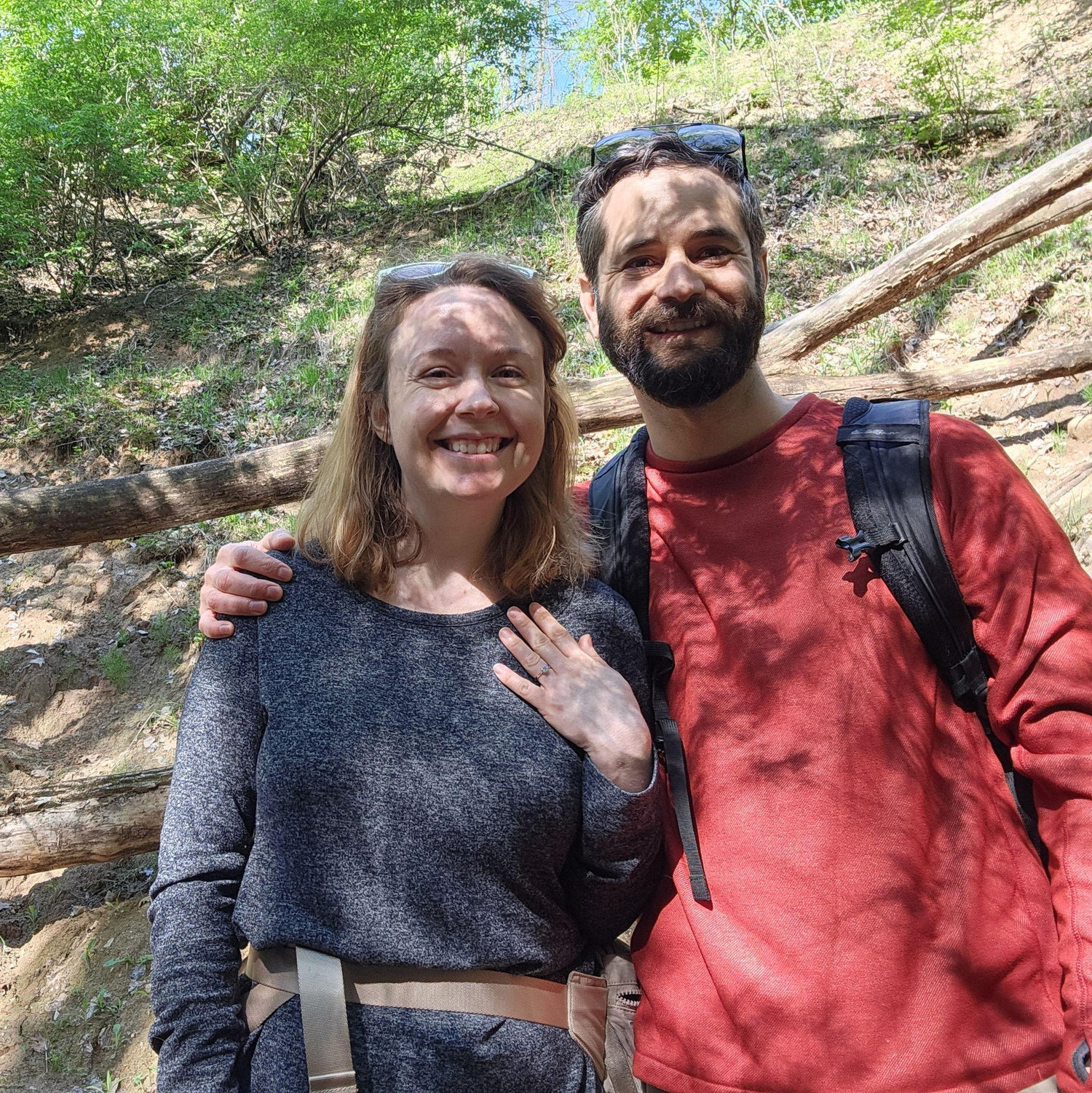 Mike proposed on a morning hike. While Liz was looking around for cool rocks in the stream bed, Mike had his own shiny rock to share. Perfectly executed. He got her good.