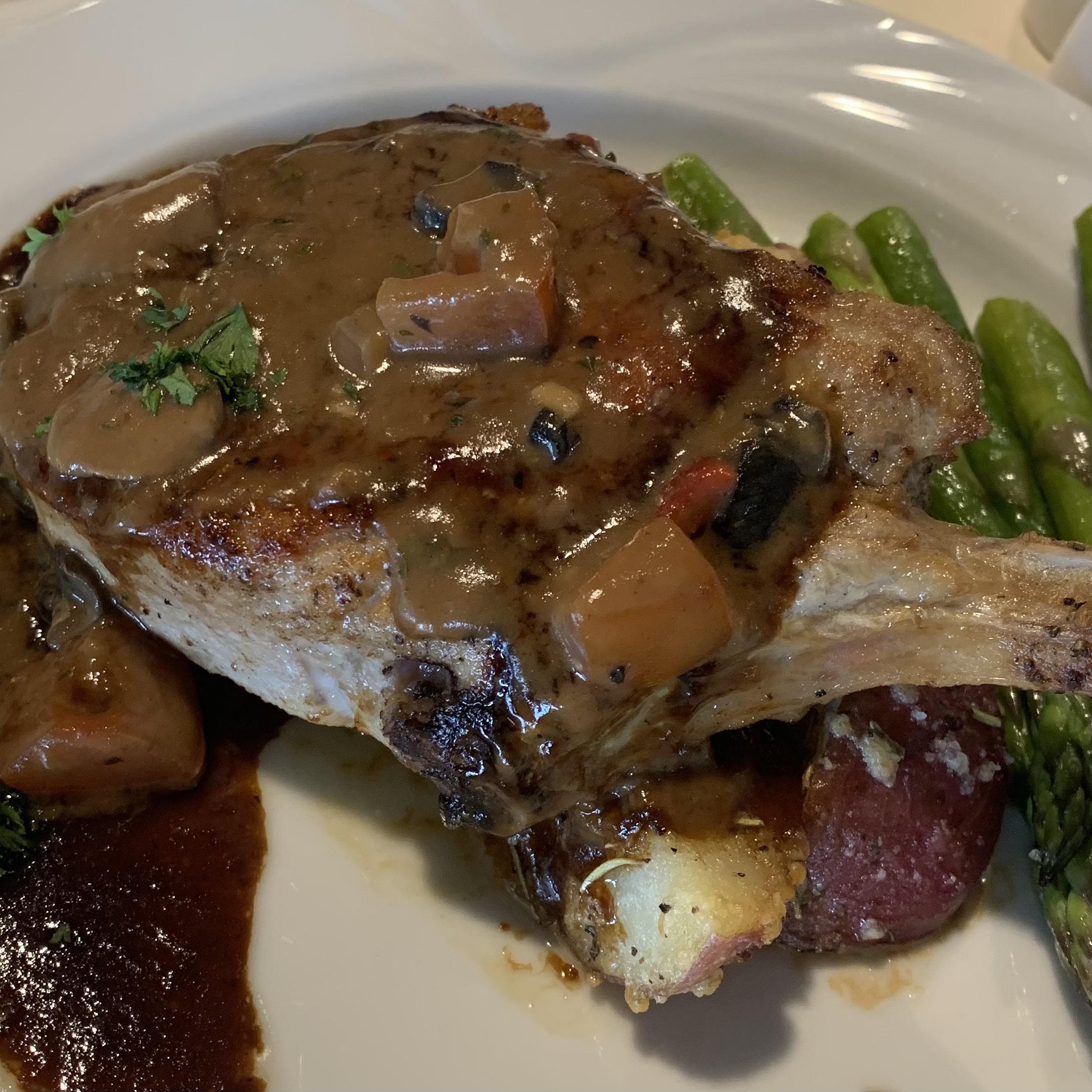 Pork Chops Forestiere:
Breaded pork loin steak sautéed with garlic, shallots, cremini mushrooms, red peppers, and asparagus with a marsala wine sauce