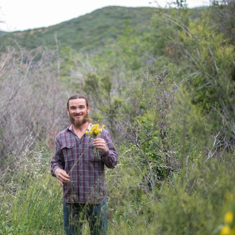His Hippie is showing. Tyler creating a wildflower bouquet on our hike back up from Silverwood Lake. Photo courtesy of Steven Widney.