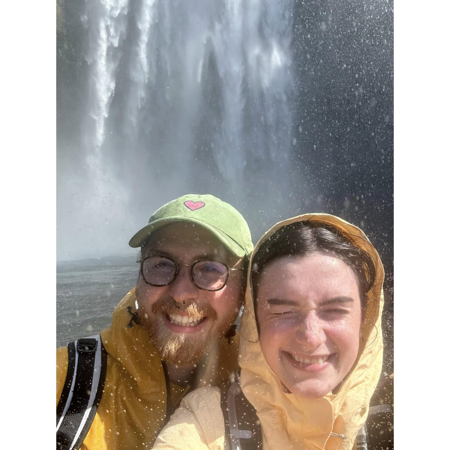 All smiles under the mighty waterfall, Skogafoss, in Iceland, 2024