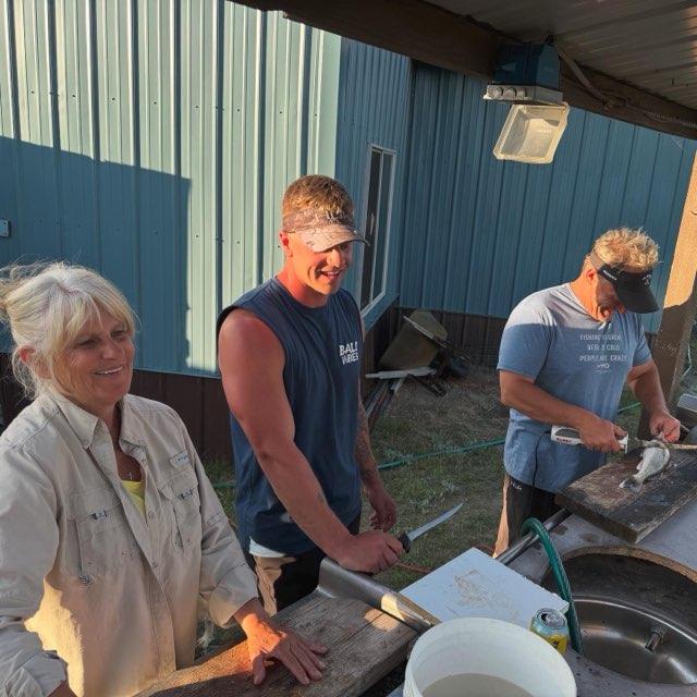 Cleaning fish at the Schlosser lake house