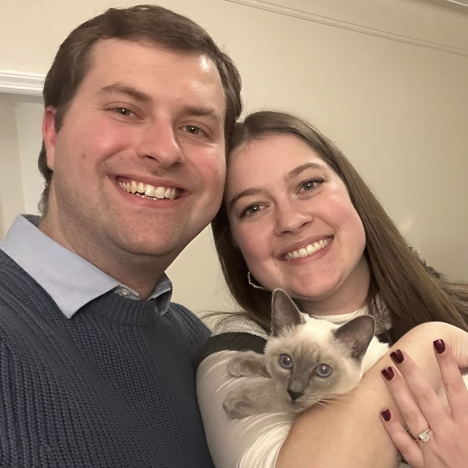 Newly engaged with our cat, Emme.