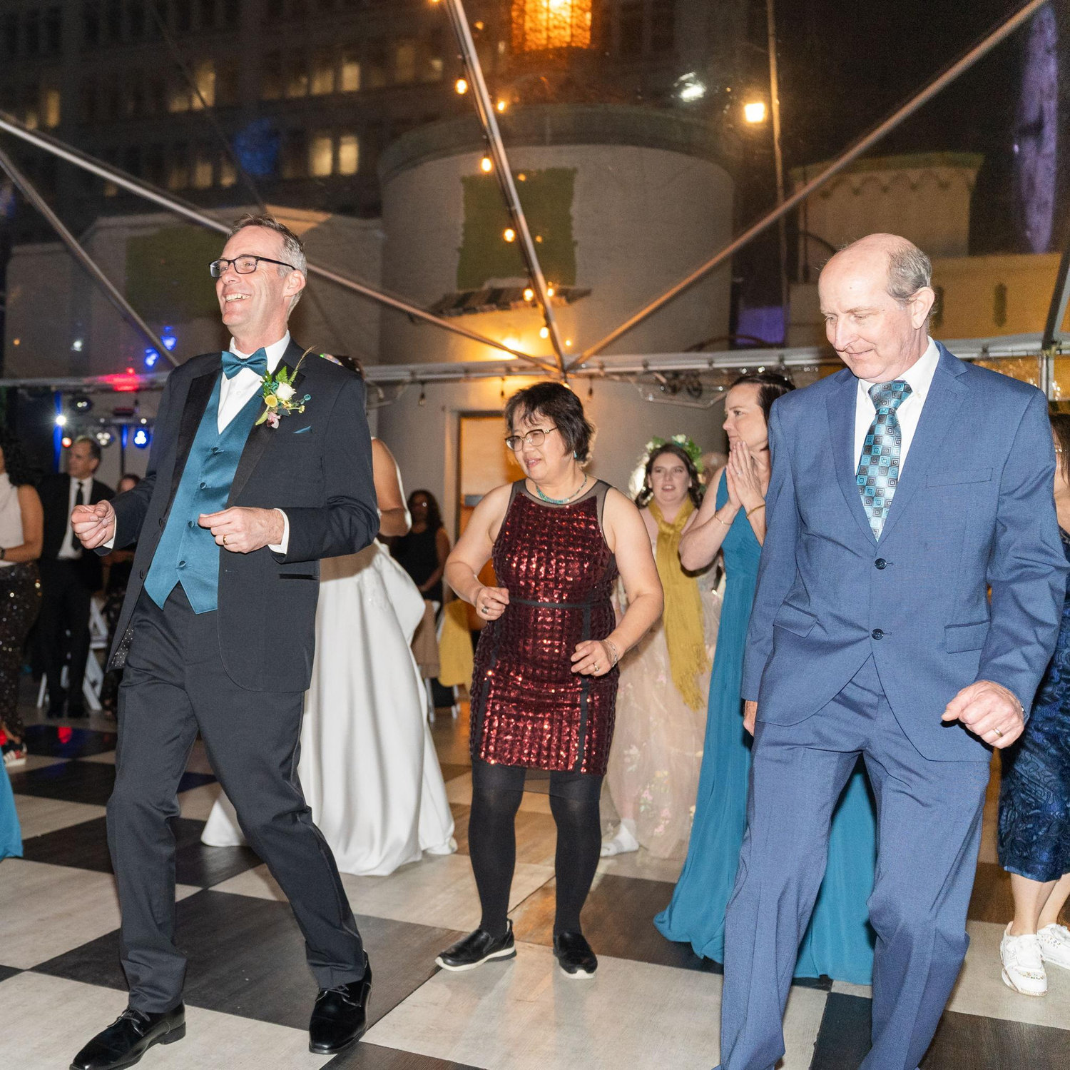 David d White and Jin  Yu cutting a rug with the groom.