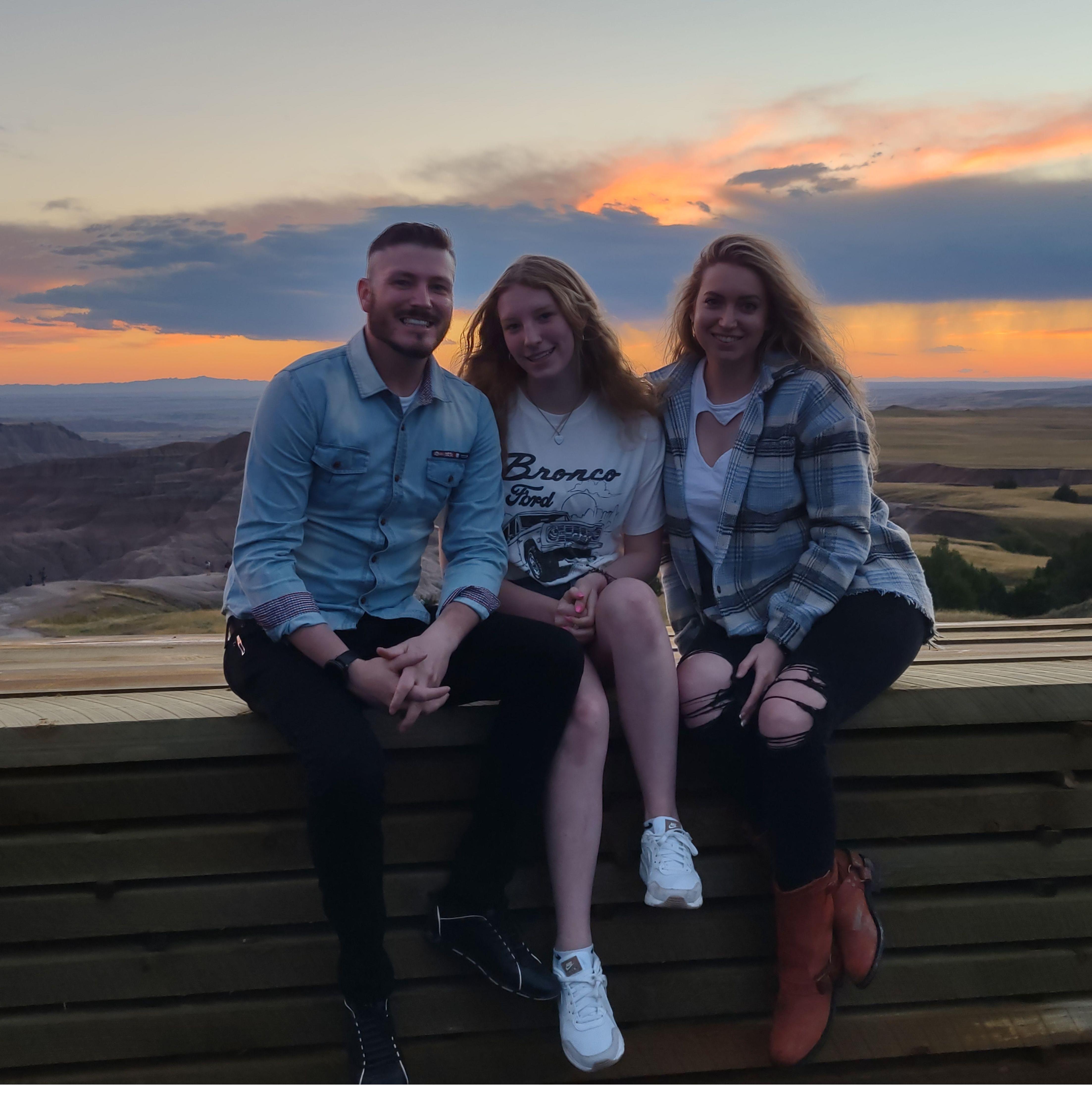 Anthony, Haylee, and Kelsey taking advantage of a stunning sunset at the Badlands National Park.
