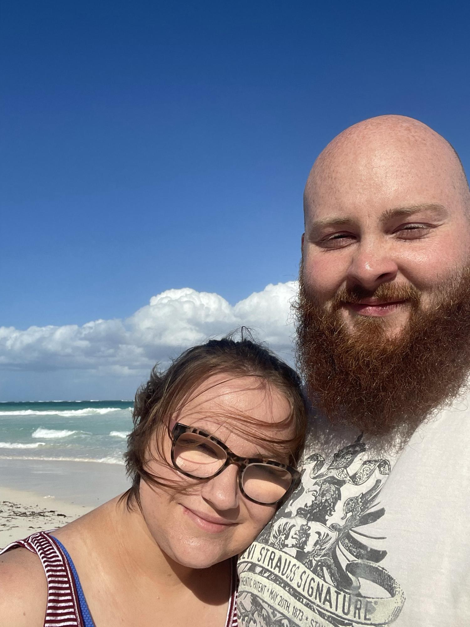On the beach in mexico. The wind would not stop blowing my hair into my face and the sun was right in our eyes.