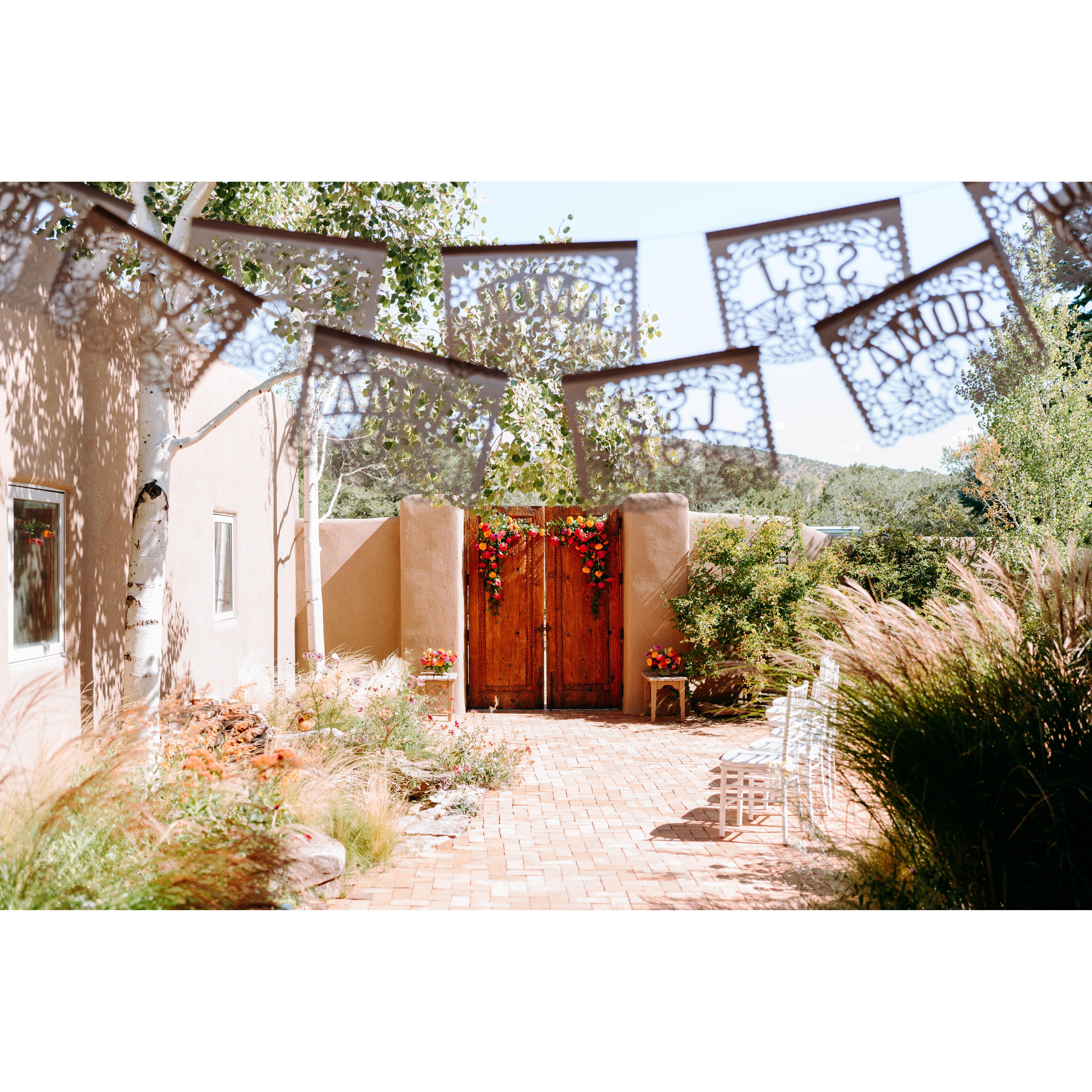White papel picado flags facing the courtyard