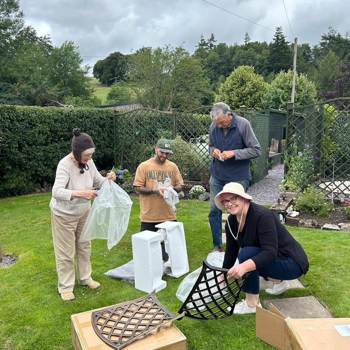 Sawyer helping Sierra's grandparents and mom put together chairs in their garden in Moniaive, Scotland