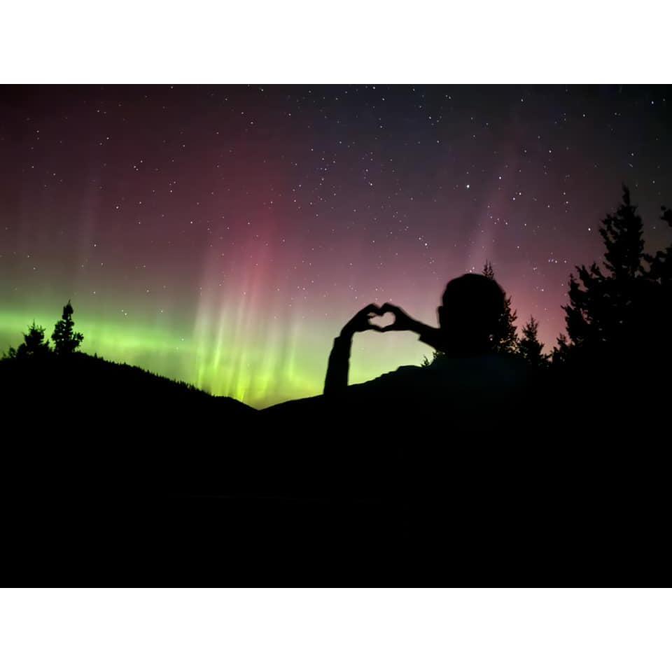 Wyatt forming a heart in front of the Aurora Borealis—a breathtaking moment to treasure.