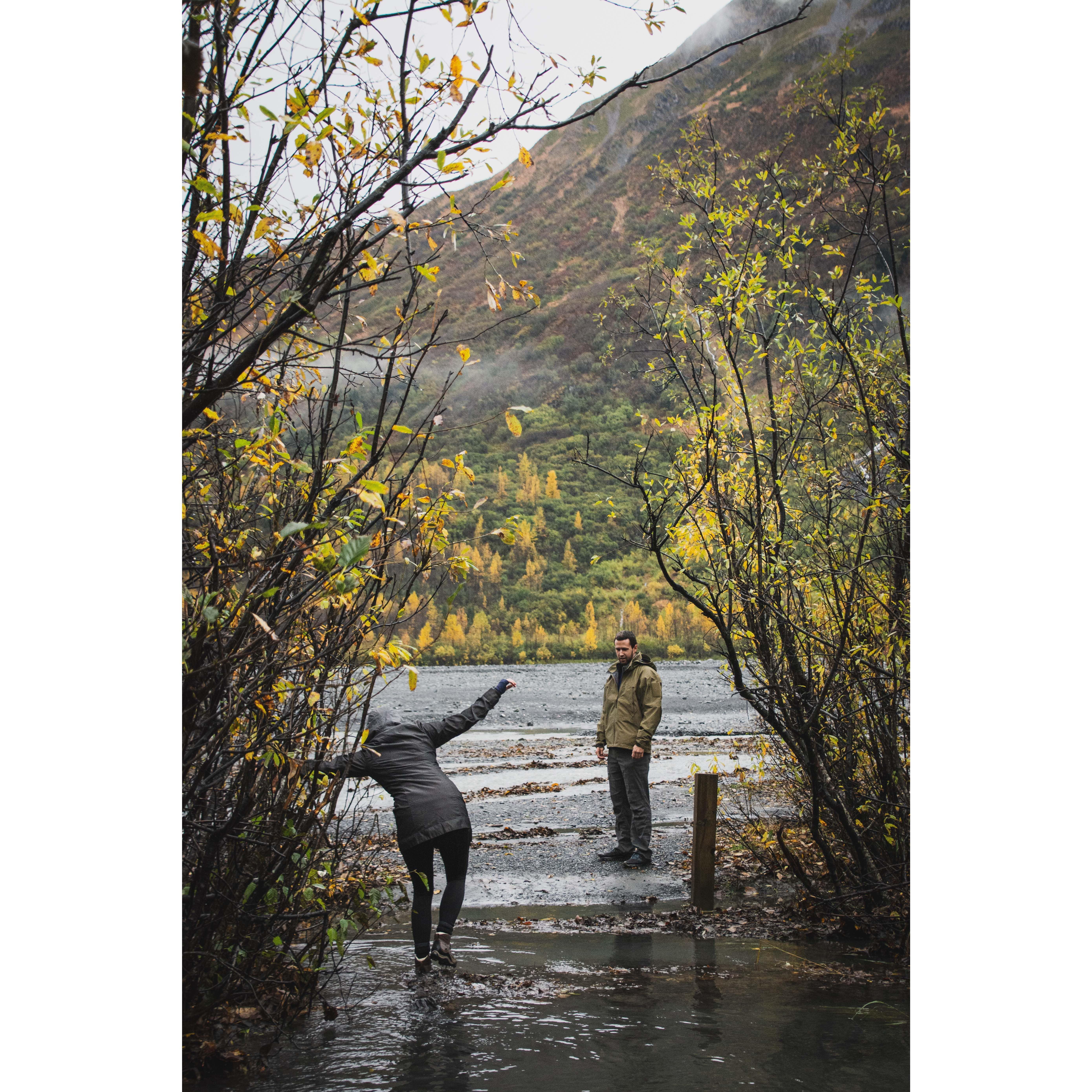 Traveling across glacier run-off water, with Keegan waiting patiently for me...
