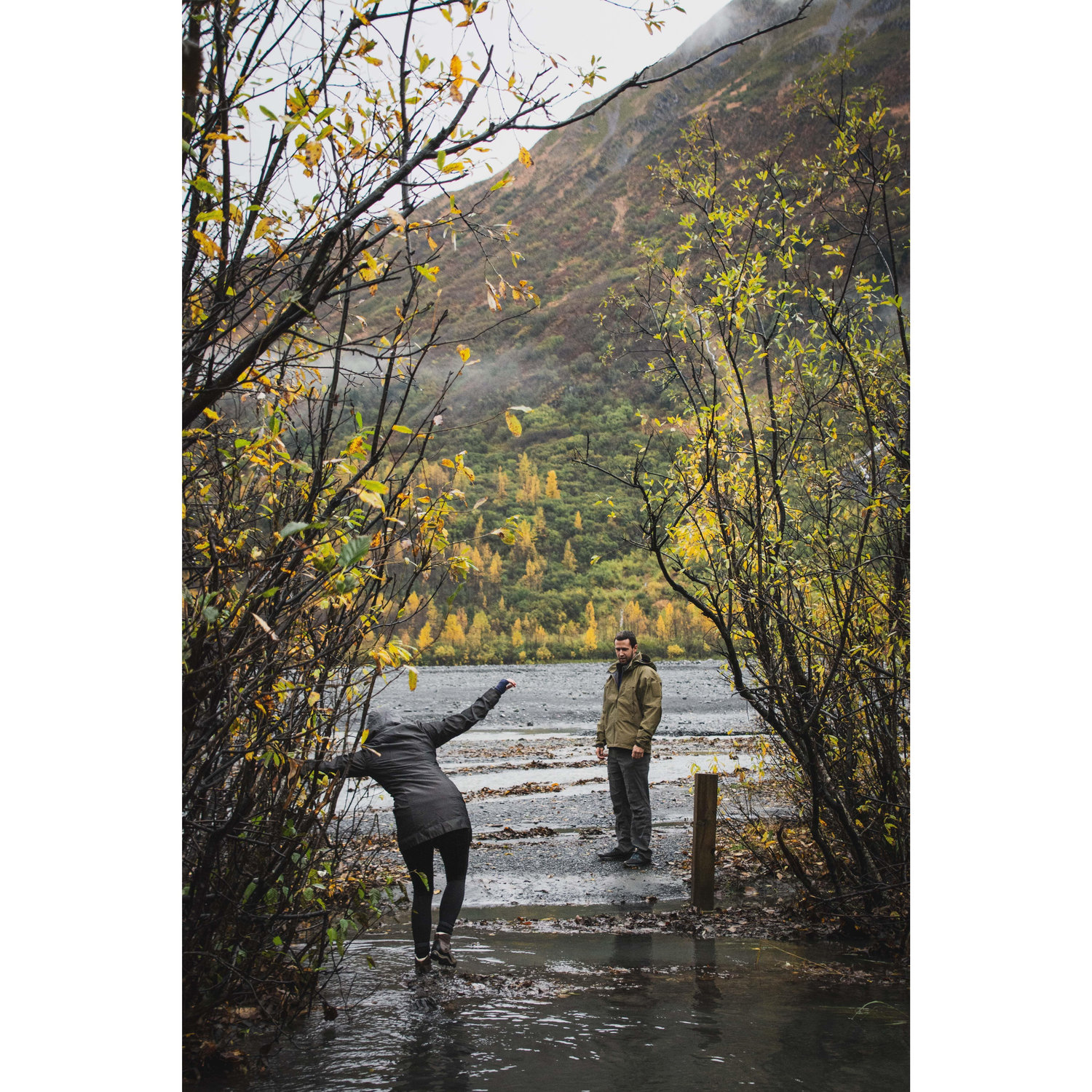Traveling across glacier run-off water, with Keegan waiting patiently for me...