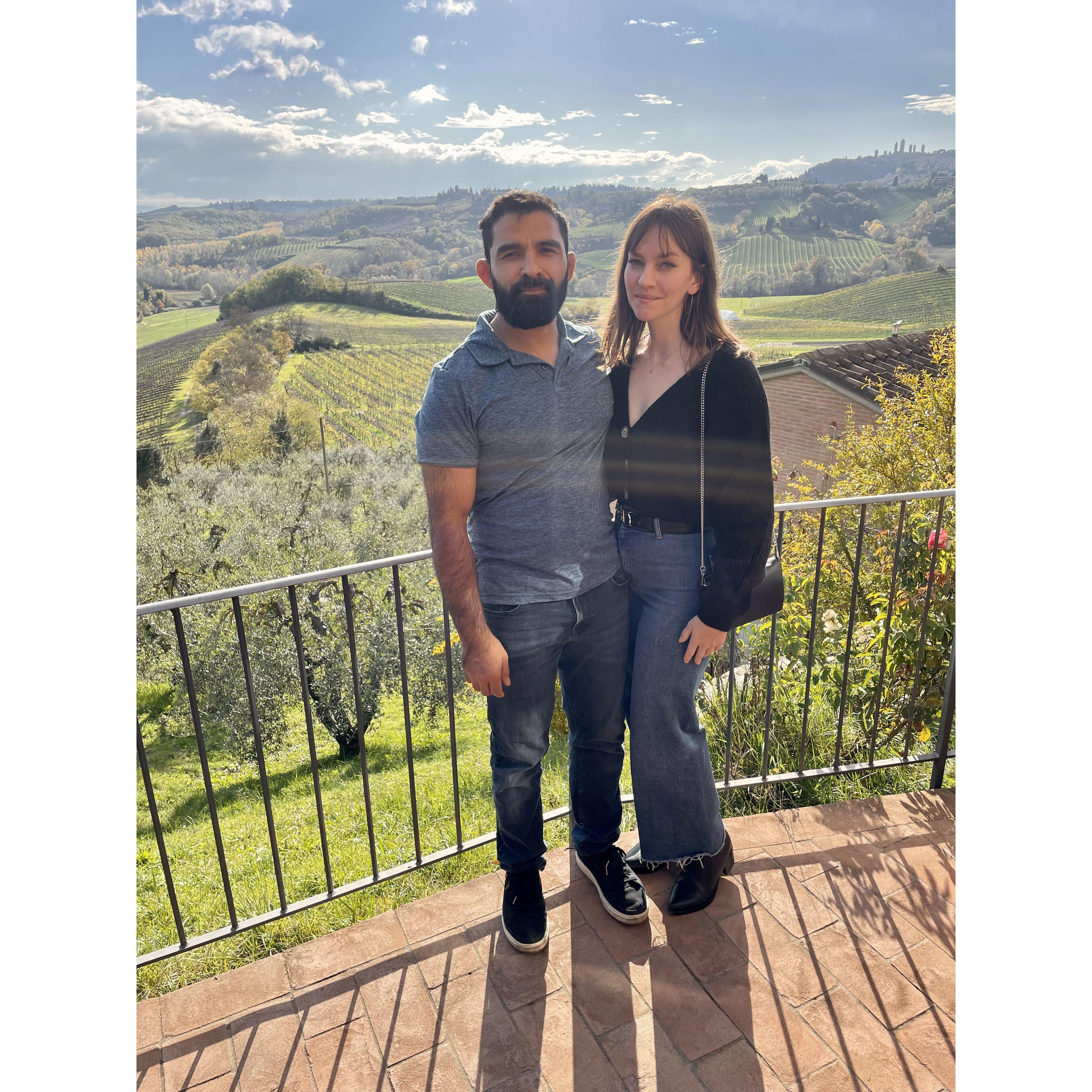 Enjoying sun and vineyards in Tuscany (Gaby secretly doesn't like most wine but enjoys the experience!)