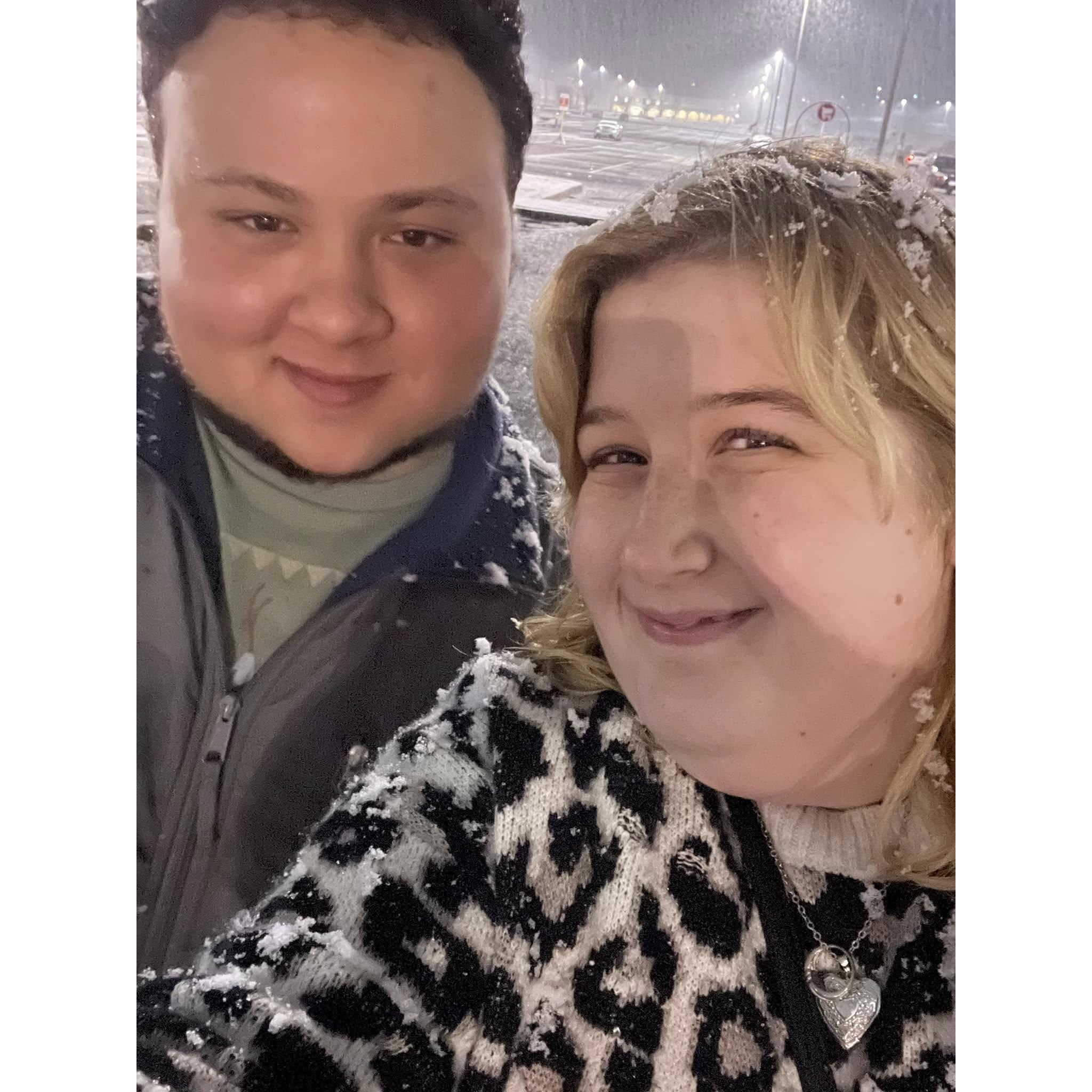 Isaac and Madison capturing their first winter moment together—smiling in the snow as it gently fell around them.