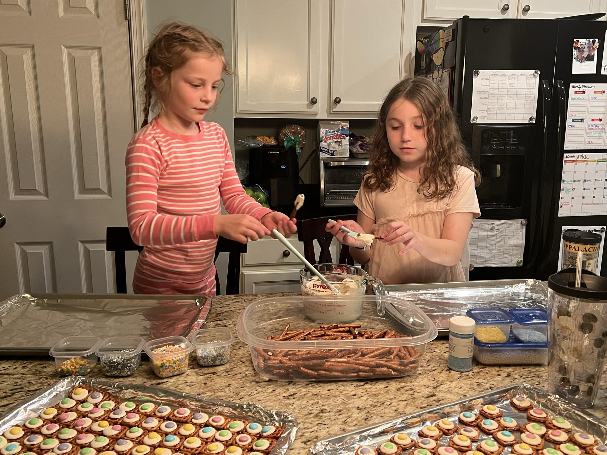 Cameron and Dorothy making chocolate covered pretzels for Easter