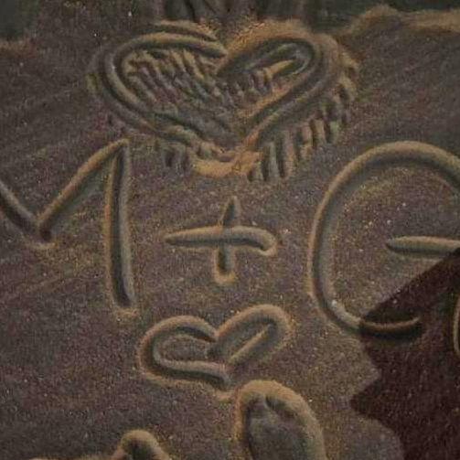 Albeit the cropped picture, I wrote our initials in the sand. My dad taking a picture of me drawing, sending it to him as a core memory.