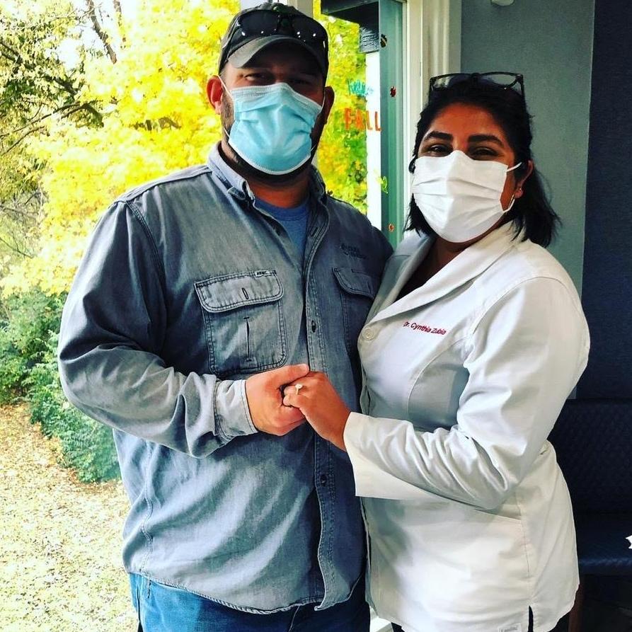 Showing off my ring and my fiancé at work after he got his teeth cleaned