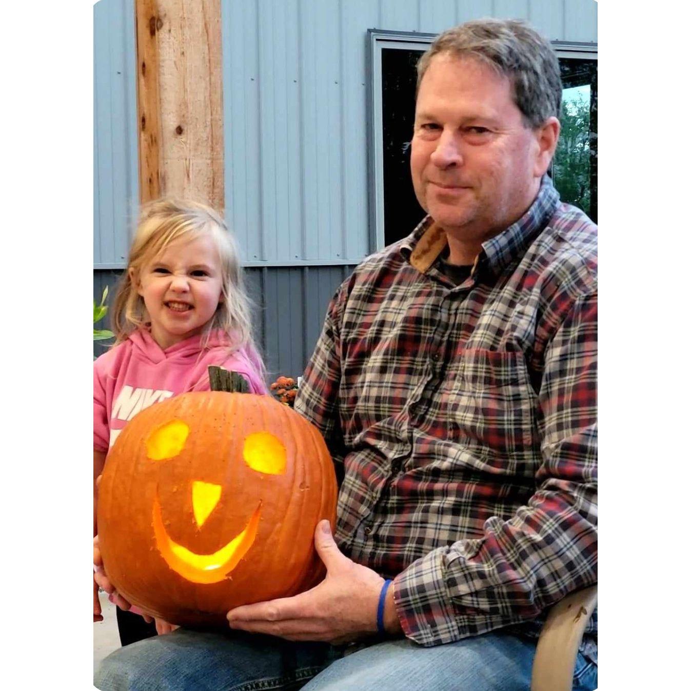 Patrick's first experience with carving pumpkins with my crew, Halloween 2023.  Scarlett's face cracks me up!