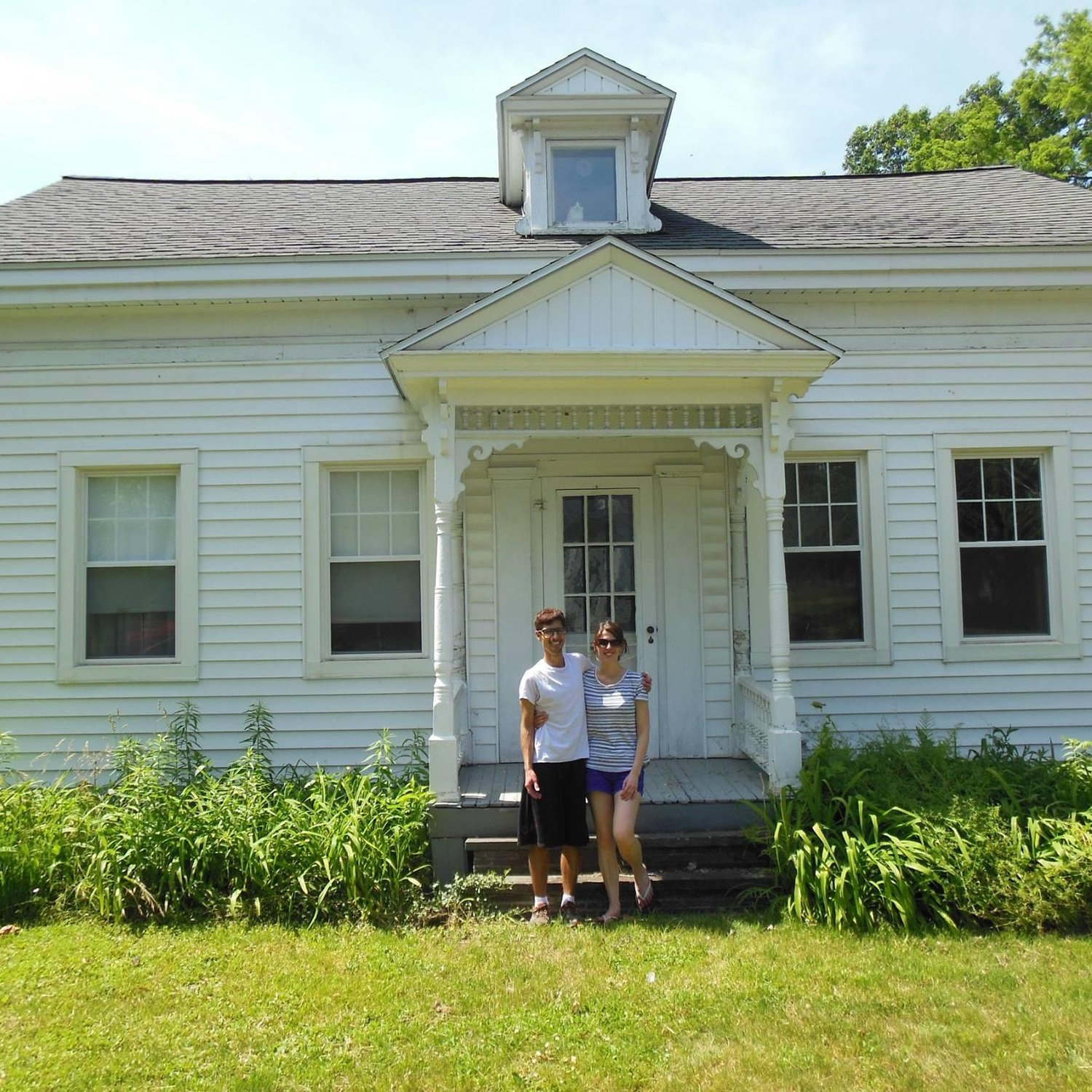 Us in front of the house we bought together