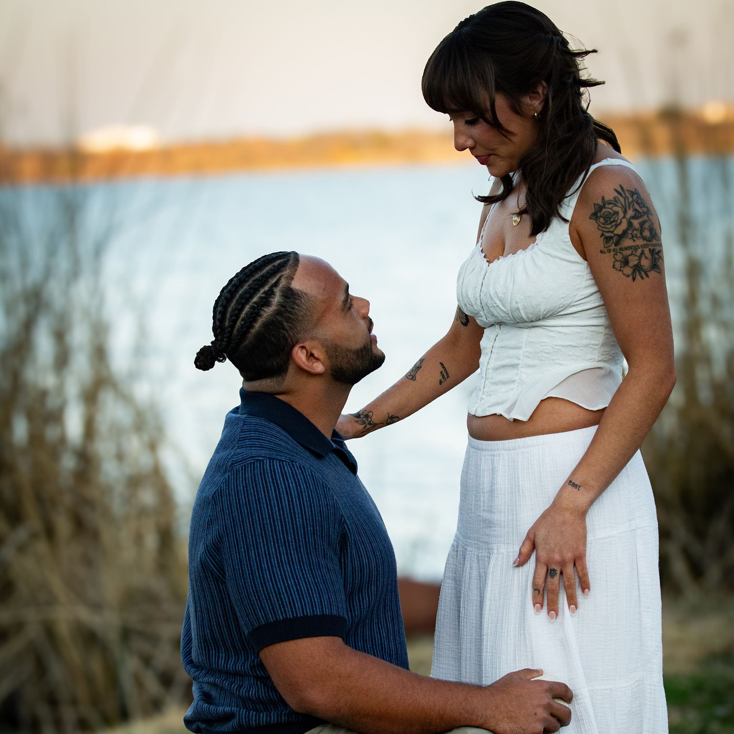 Jace proposed on 2.28.26 at White Rock Lake, where we had our second date. He took her on a walk after dinner. A lady handed her a gift bag with a shirt in it that had the date and a bible verse on it