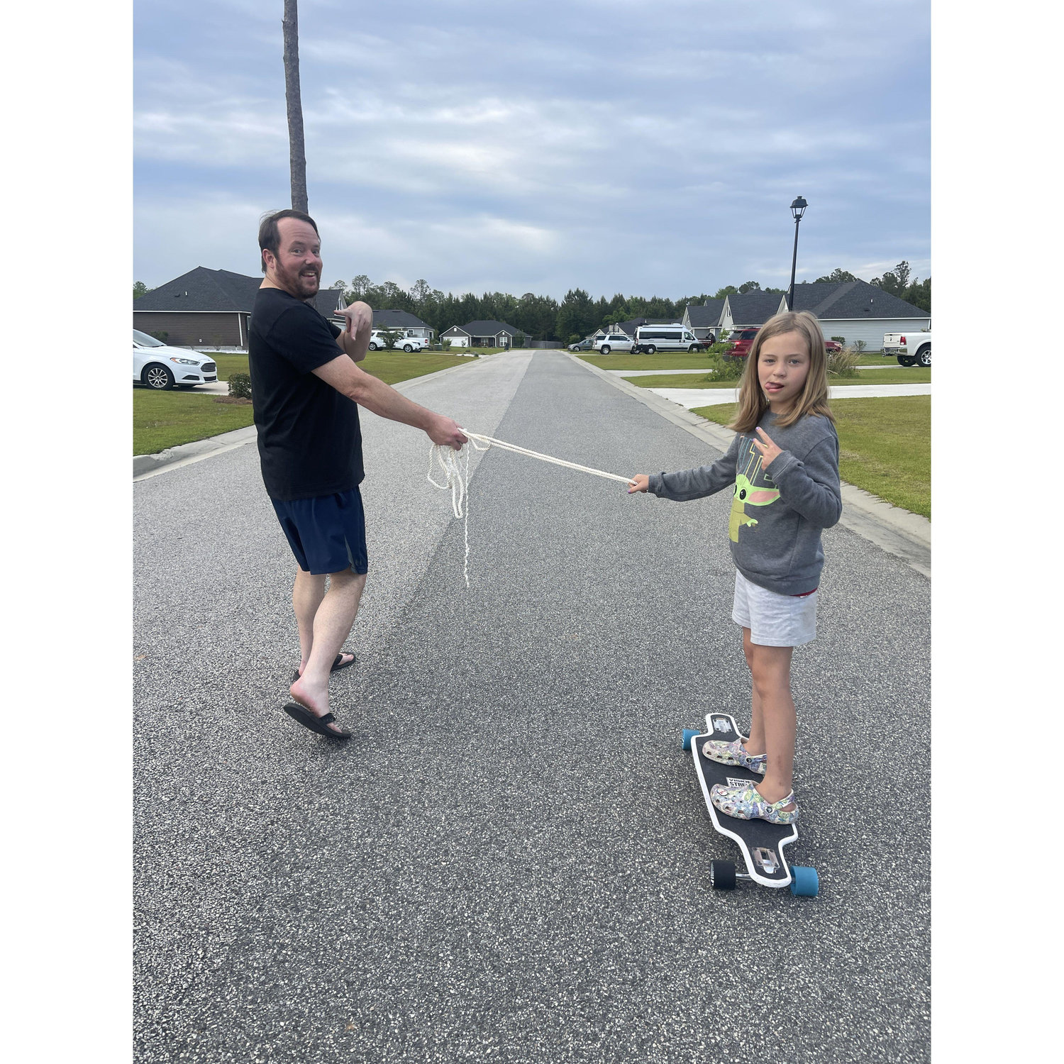 Scott teaching Kinsley how to skateboard.