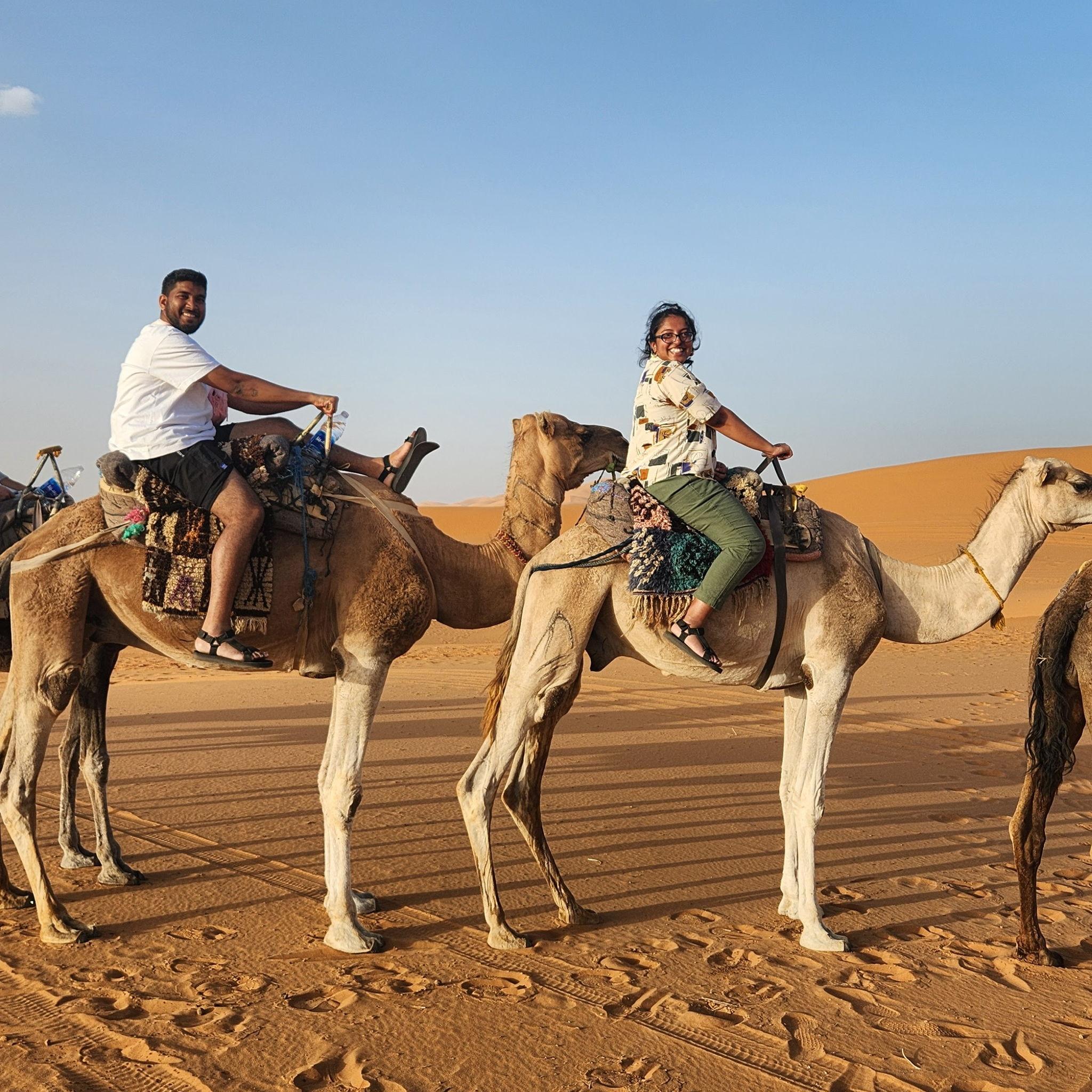 Us riding our camels into our desert camp. The ride was an hour long - ouch!
