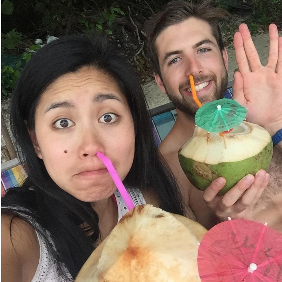 Drinking coconuts on a beach in Phuket, Thailand.
