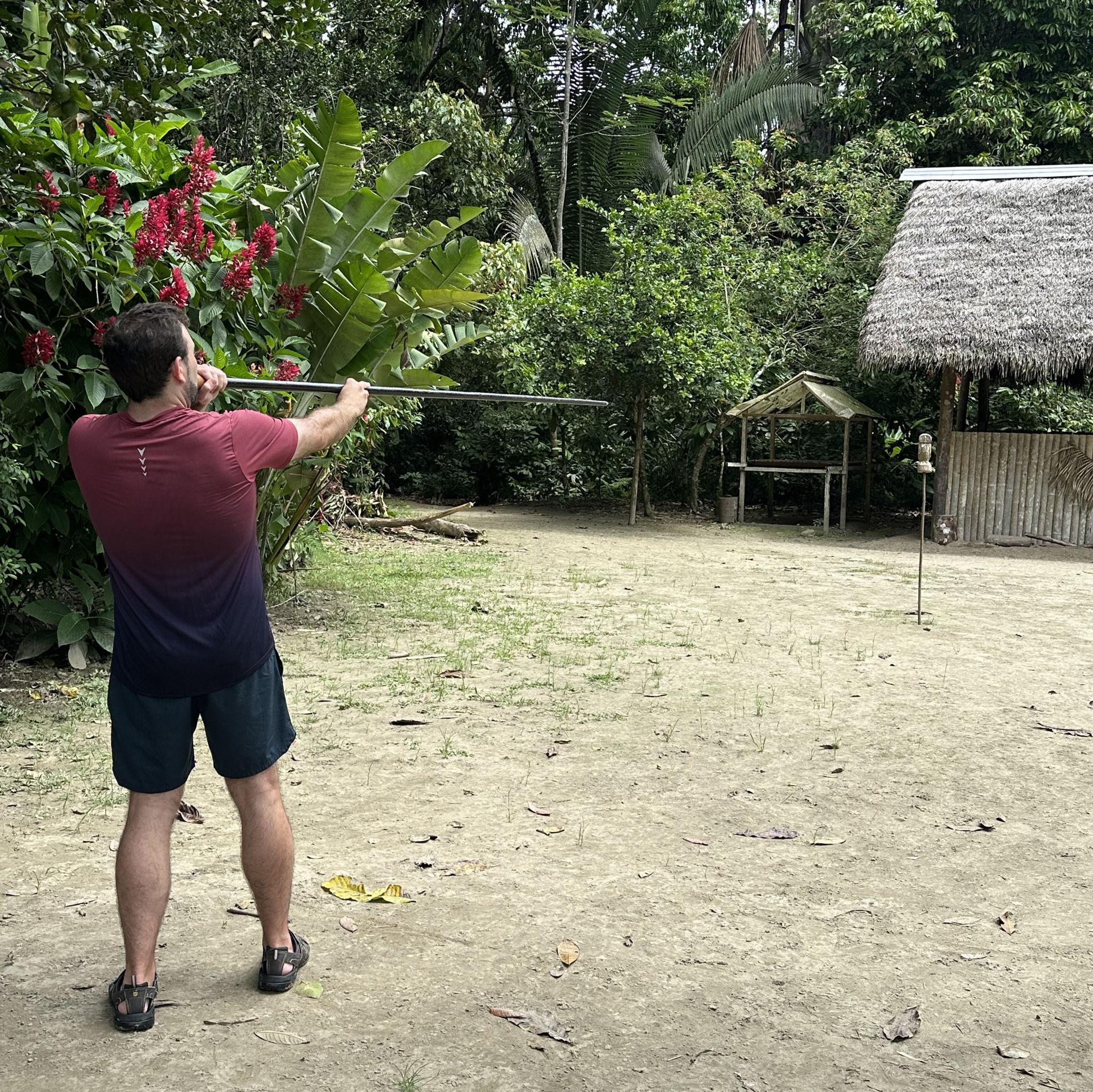 Amazon - Michael testing his aim with a traditional mouth-blow dart, just like the Indigenous communities of the region.