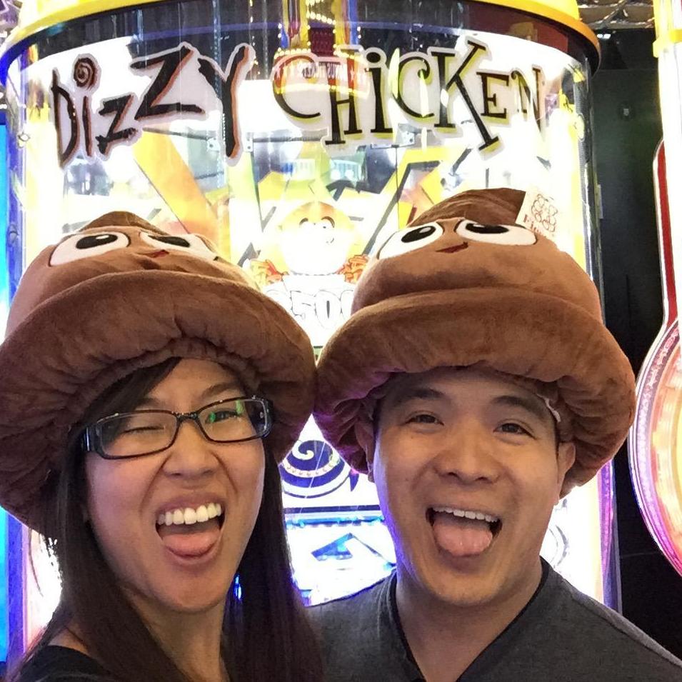 Us being poopy heads. We spent hours playing "Dizzy Chicken" for our second year anniversary weekend to win these hats!! (September 2016)