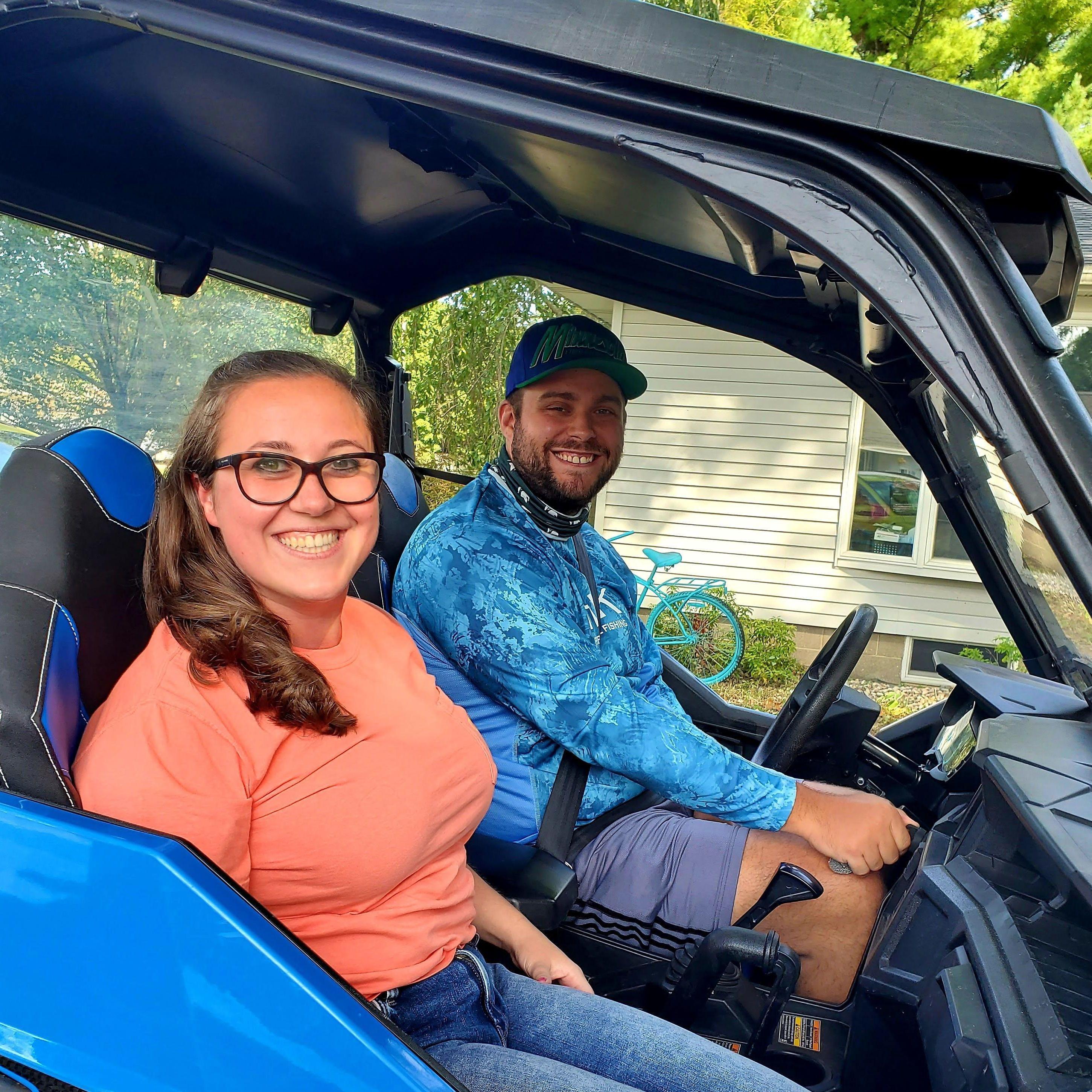 This is one of Maeghan's favorite picture - taken at Keiran's Dad's house in his UTV!

Alt Text: Maeghan and Keiran sitting next to each other inside a blue UTV/side-by-side