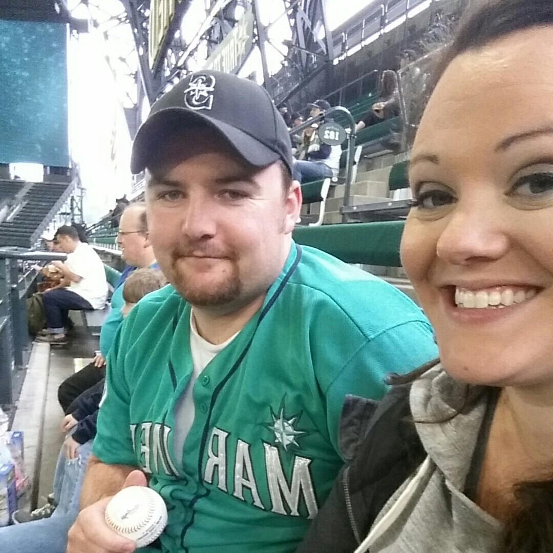 At a Mariners game last year. Eric caught a home run ball from Nelson Cruz during warm ups! Ashly threw her cheeseburger all over Eric's leg trying to duck out of the way from it.