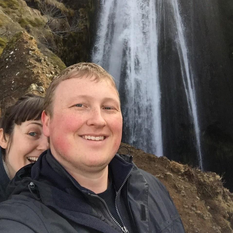 Brother and sister near a waterfall