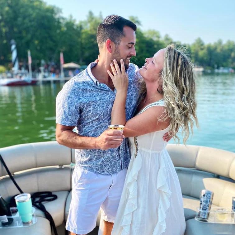 When Matt proposed on the boat on Ten Mile (notice the Godbersen lighthouse in the back), 2021