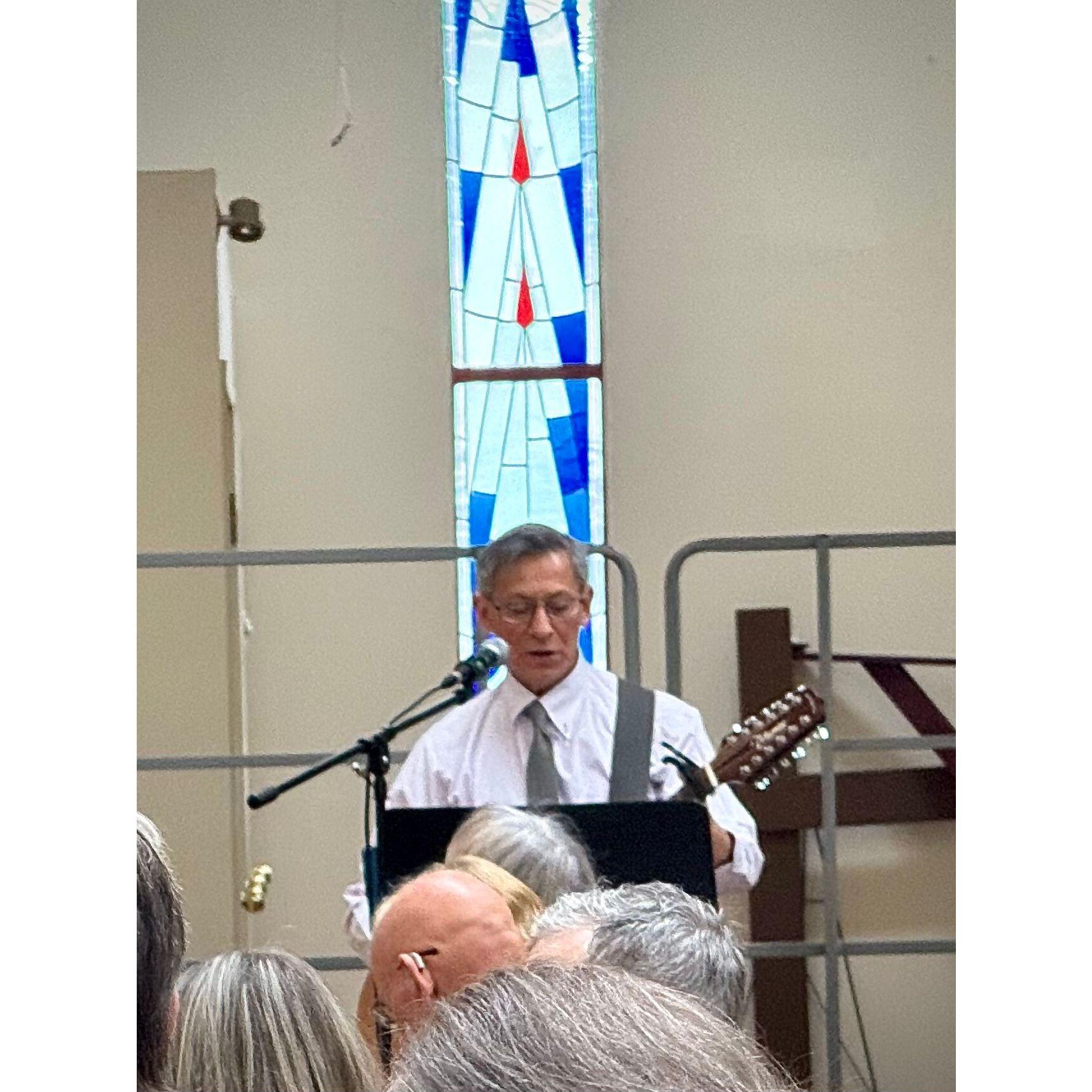 George sings the hymn "BIND US TOGETHER".