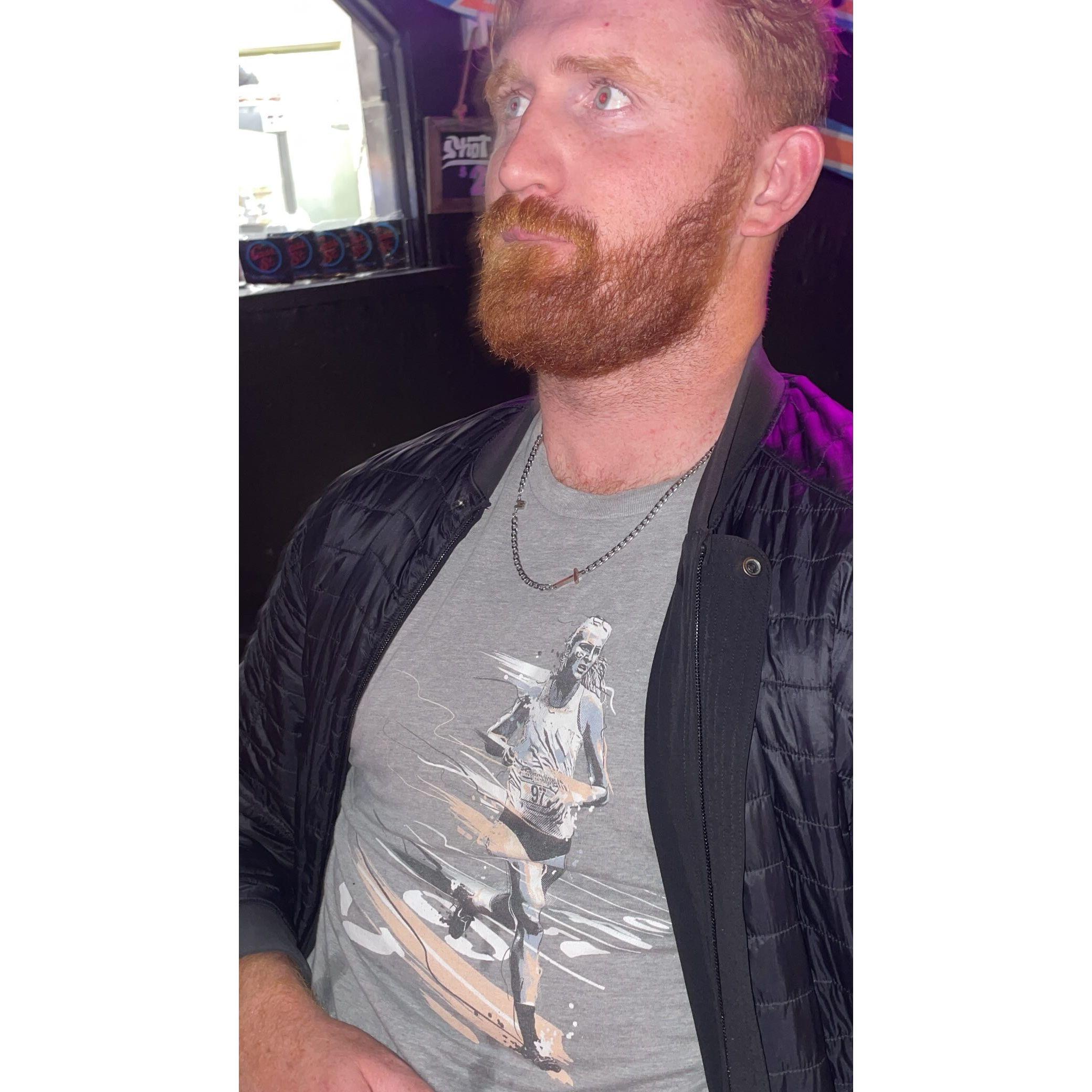 Emma forcing Ian to wear a shirt with her running on it.