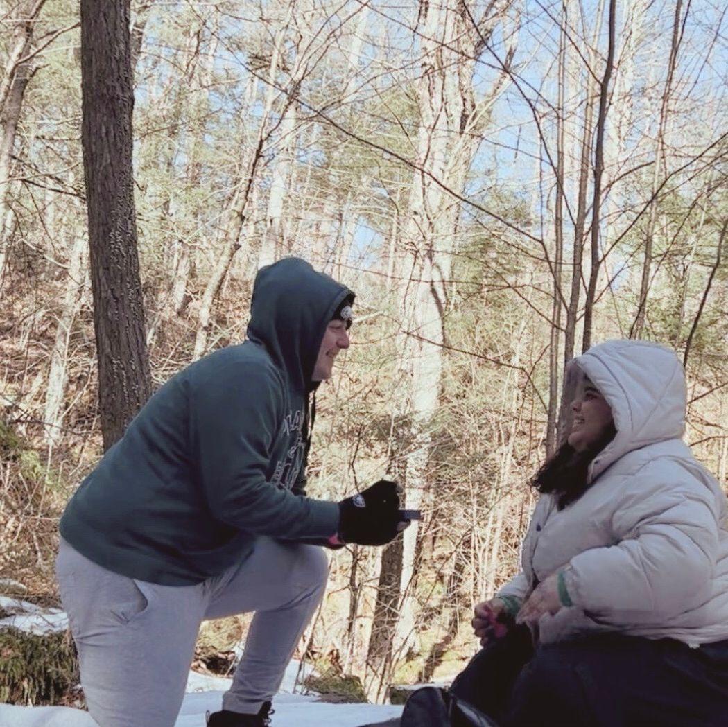 The proposal!! (She had to sit because they were on an icy mountain)