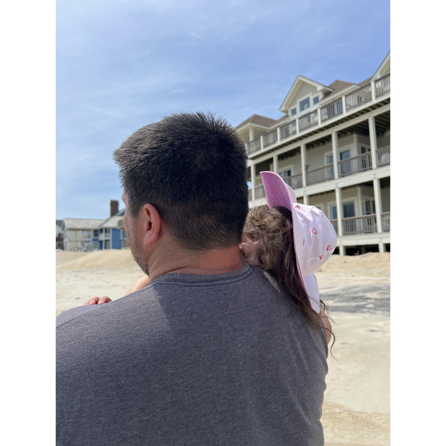 At the Outer Banks! Penelope was too tired to walk back and fell asleep on Chris 🥰