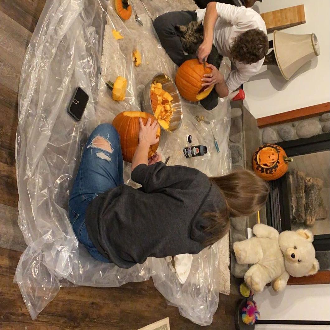Carving pumpkins together.