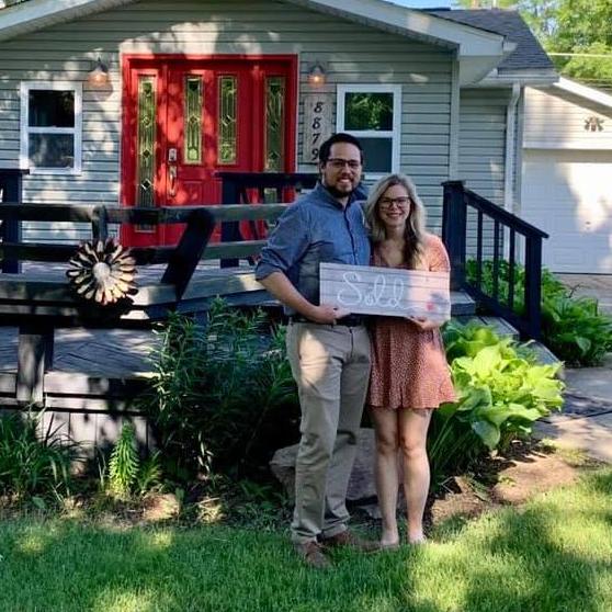 Standing outside of our first home together right after our closing.